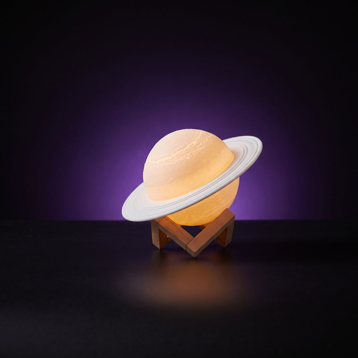 Y2K Saturn Lamp – studio product shot on dark background with purple glow